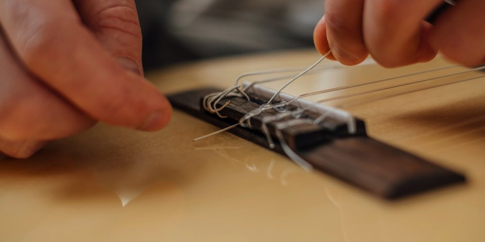 Fixing the strings to the bridge