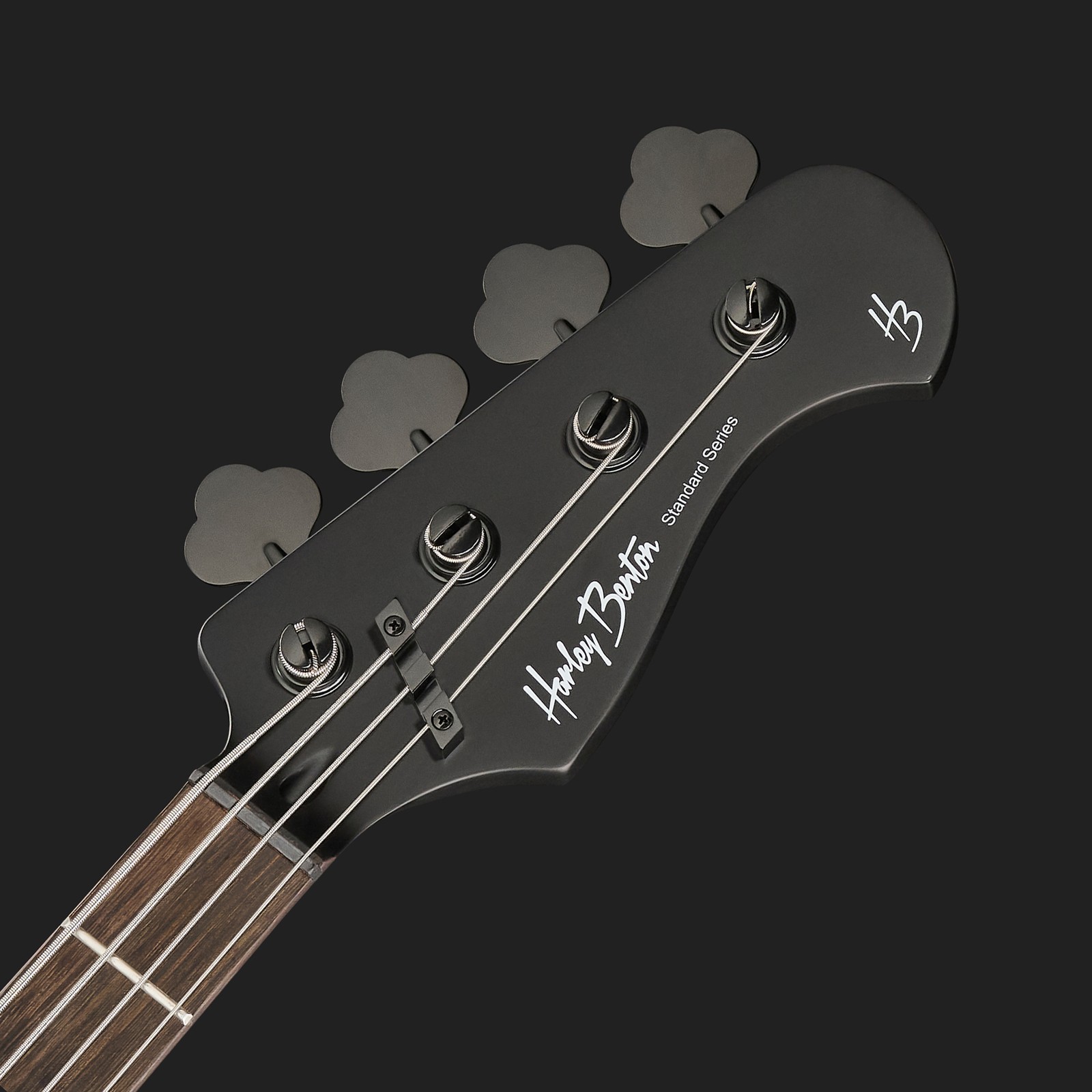 black headstock and fretboard of a four string bass