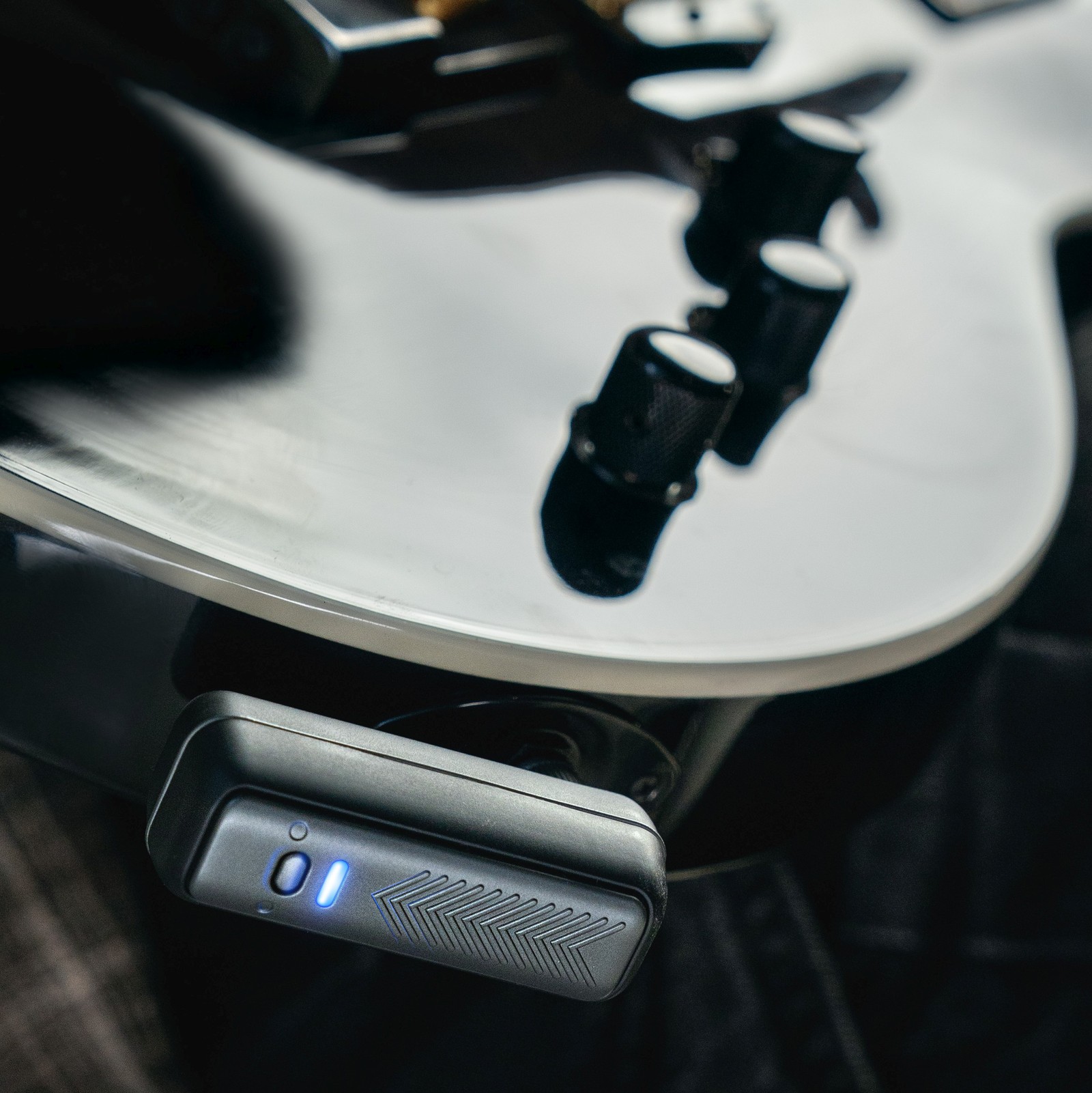 Positive Grid Spark Neo radio transmitter on a black electric guitar