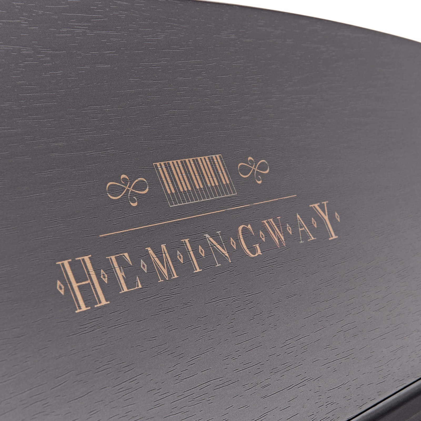 Goldenes Hemingway Logo auf dem schwarzen Notenhalter