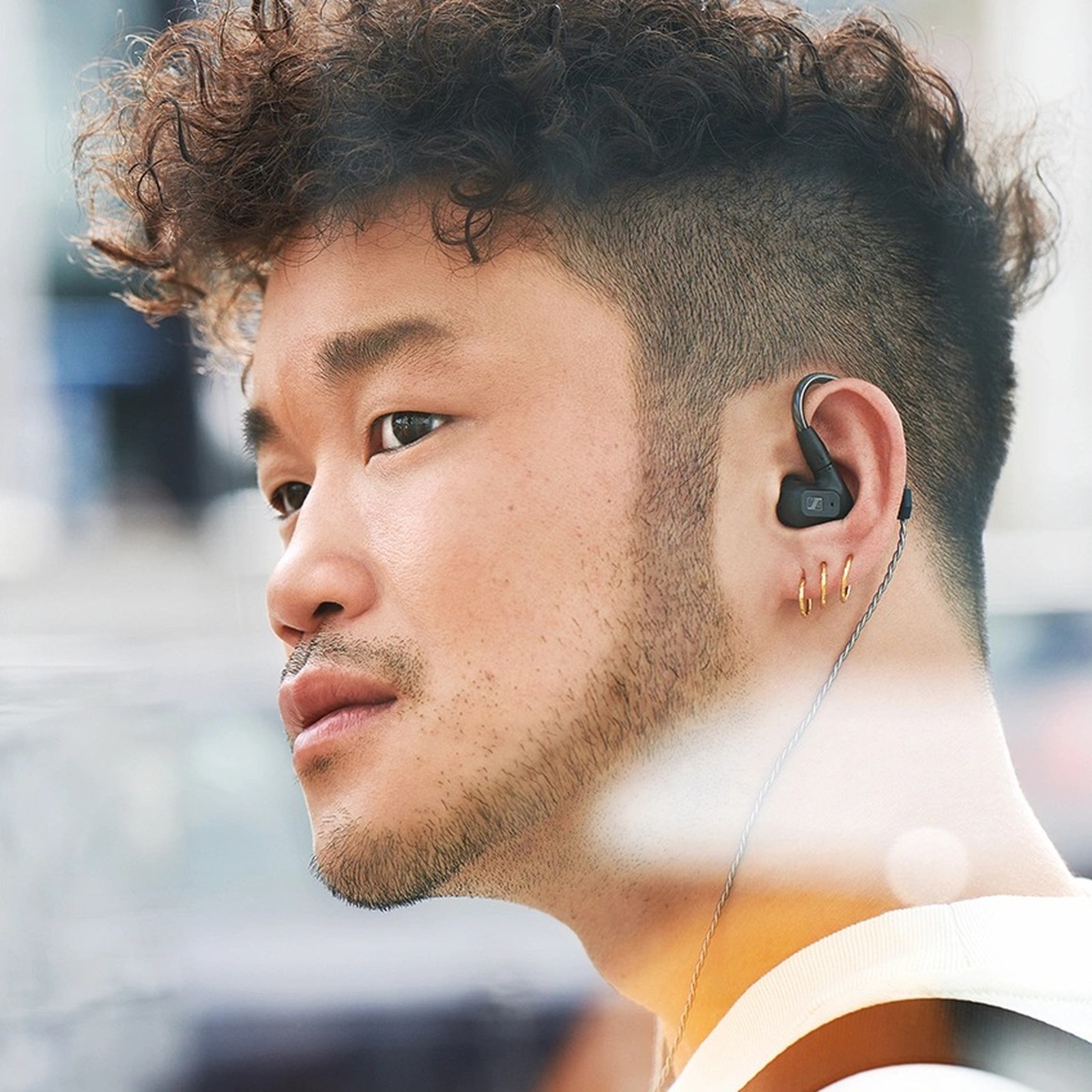 Man wearing Sennheiser IE 200 headphones